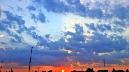 Low angle view of silhouette trees against sky at sunset