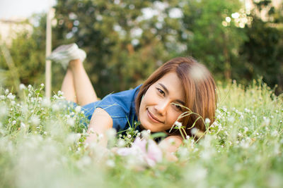 Portrait of woman resting on field