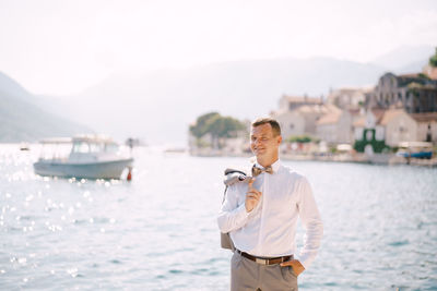 Portrait of young man standing in boat