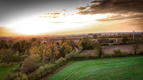 Scenic view of field against sky during sunset