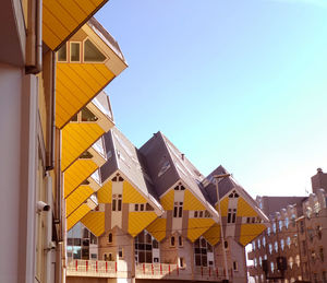 Low angle view of yellow buildings against clear sky