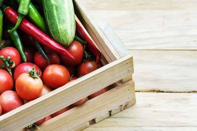 High angle view of tomatoes in wooden container on table