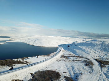 Scenic view of snow covered landscape against sky