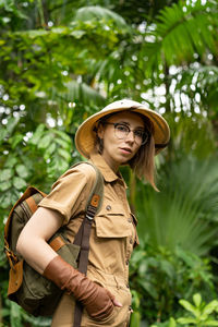 Portrait of woman standing in forest