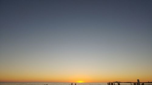 Scenic view of sea against clear sky during sunset
