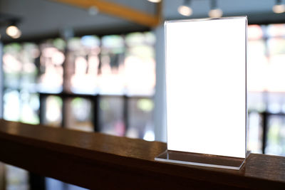 Close-up of blank placard on table at restaurant