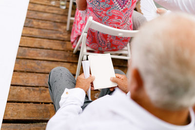 Low section of people sitting on table