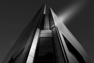 Low angle view of skyscraper against sky at night