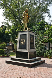 Statue of cemetery against trees