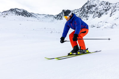 Full length of man skiing on snowcapped mountain