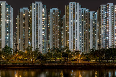 Illuminated buildings against sky at night