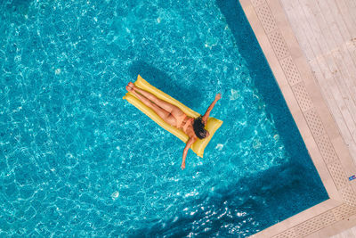 High angle view of woman swimming in pool