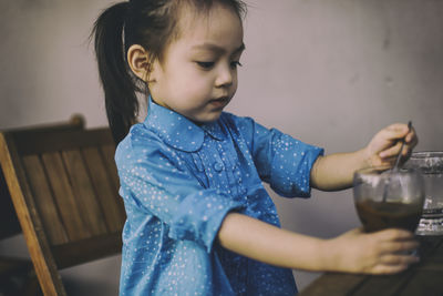 Close-up of cute girl holding drink