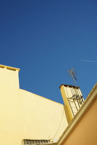 Low angle view of built structure against clear blue sky