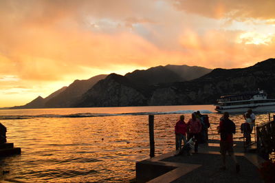 Scenic view of sea against cloudy sky at sunset