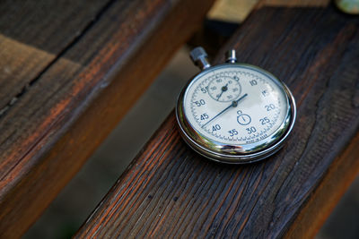 High angle view of pocket watch on table