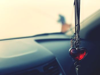 Close-up of heart shape decoration hanging in car