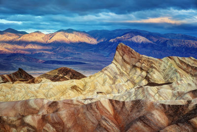 Scenic view of mountains against cloudy sky