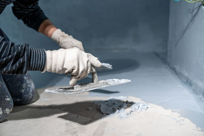 Cropped hand of man working at workshop