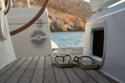 Close-up of laptop on table by sea