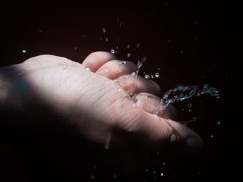 Close-up of hand with water drops