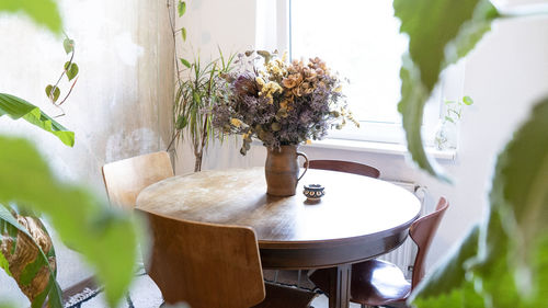 Potted plant on table by window