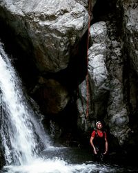 Rear view of man standing on cliff