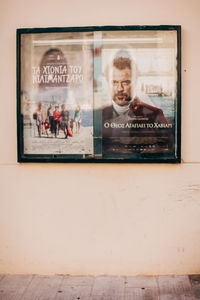 Portrait of man photographing through window