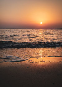 Scenic view of sea against romantic sky at sunset