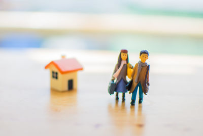 Close-up of figurines and model homes on table