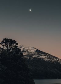 Scenic view of landscape against clear sky at night