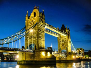 Low angle view of illuminated bridge against sky at night