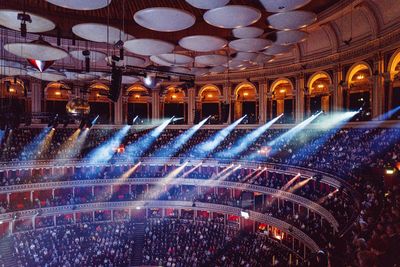 Group of people in illuminated auditorium at night