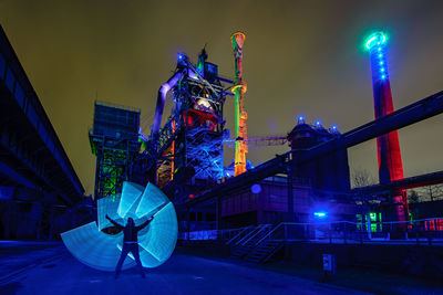 Full length of man standing by light painting at night