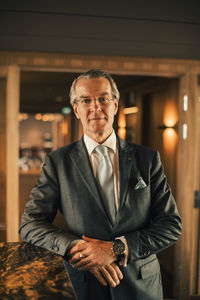 Portrait of confident mature lawyer in suit at legal office