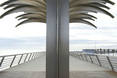 Close-up of pier by sea against sky