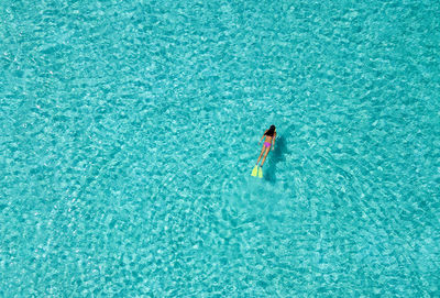 High angle view of woman swimming in sea