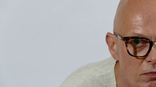 Portrait of man wearing eyeglasses