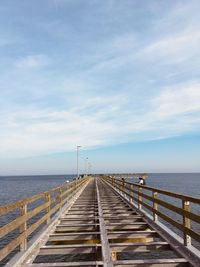 Pier over sea against sky