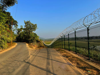 Road beside fence separating two countries india and bangladesh 