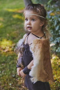 Cute baby dressed in the clothes of primitive people