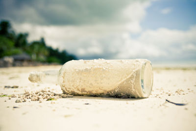 Sand in bottle on shore at beach