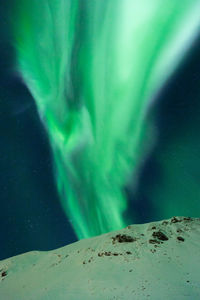 Scenic view of snowcapped landscape against sky at night