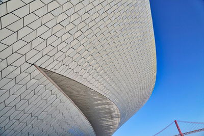 Low angle view of modern building against blue sky