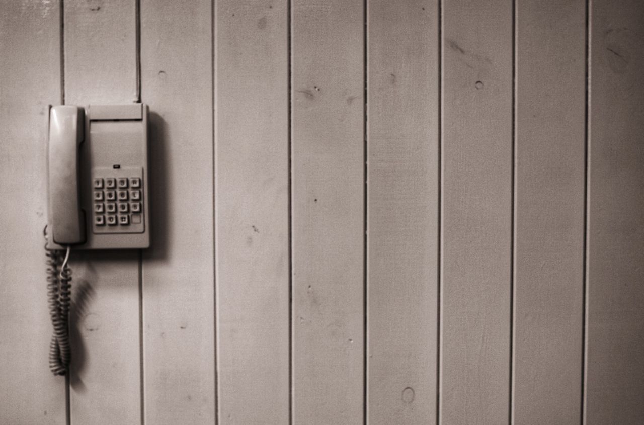 technology, communication, wall - building feature, connection, electricity, pattern, no people, wood - material, telephone, indoors, close-up, cable, safety, security, telecommunications equipment, push button, power supply, still life, electrical equipment, landline phone