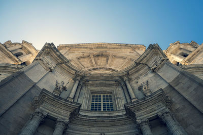 Low angle view of historical building against clear blue sky