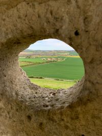 Scenic view of landscape seen through hole