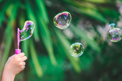 Close-up of hand holding bubbles