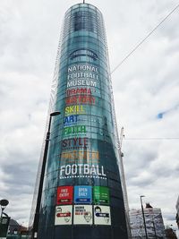 Low angle view of road sign against sky