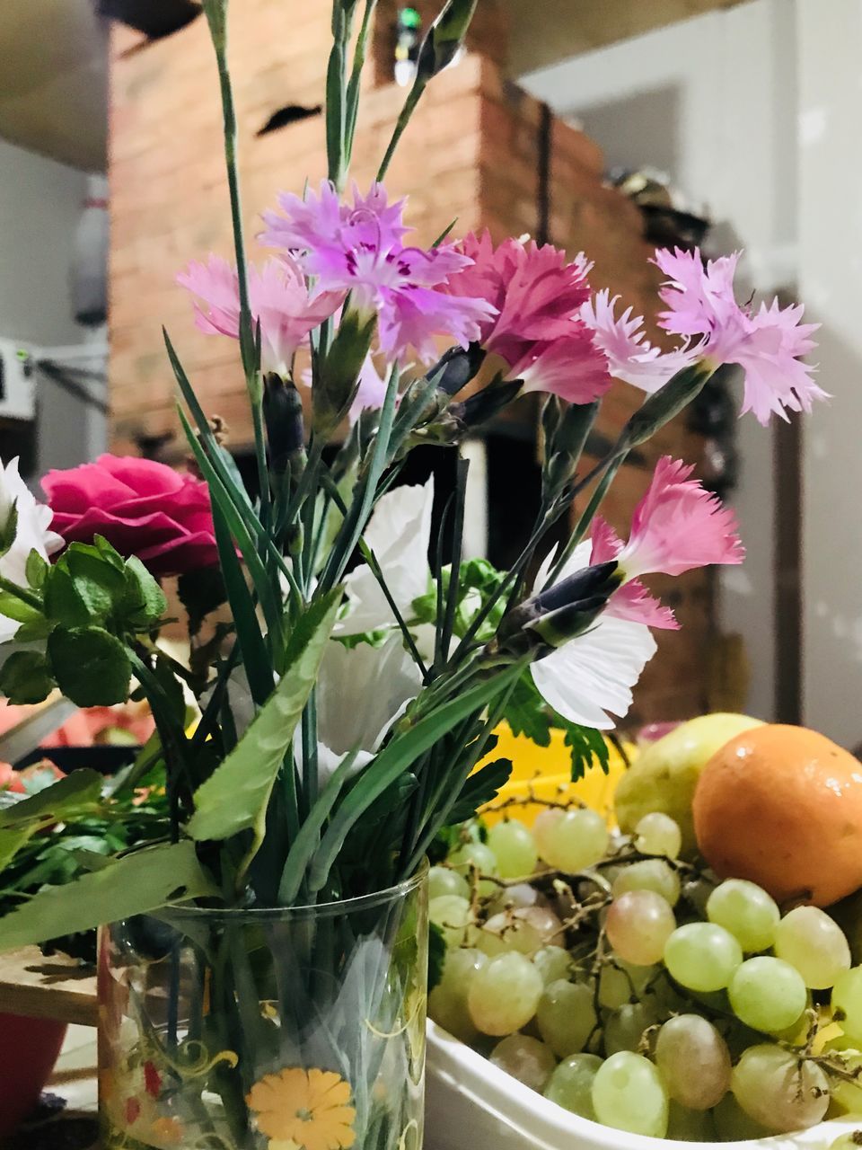 flower, flowering plant, freshness, plant, vase, fragility, vulnerability, beauty in nature, indoors, close-up, nature, no people, food, glass - material, variation, arrangement, fruit, food and drink, flower head, healthy eating, flower arrangement, glass, purple, bouquet